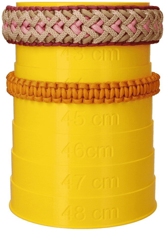 two paracord dog collars compared on a measuring tower