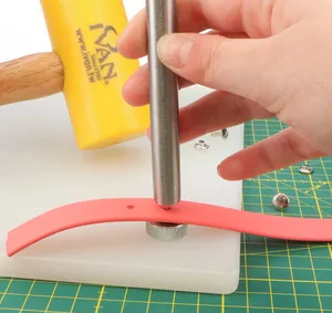 Setting a rivet by hand with punch, hammer, anvil