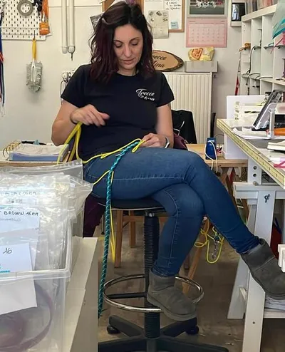 Daria knotting in her workspace